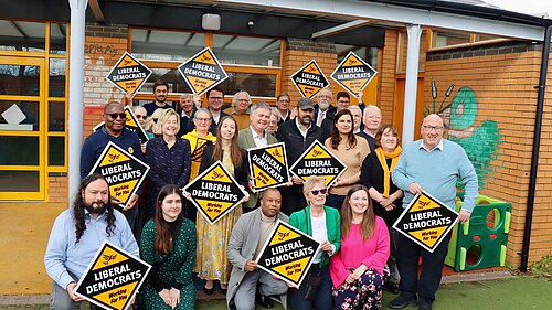 A picture of a group of Liberal Democrat activists, some of who are holding Lib Dem diamonds