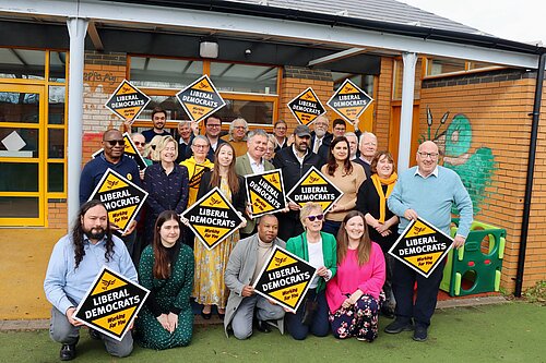 A picture of a group of Liberal Democrat activists, some of who are holding Lib Dem diamonds