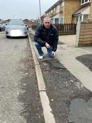 Andy Carr with damaged footpath awaiting repair