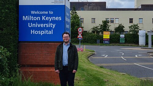 James Cox standing at the front of Milton Keynes Hospital