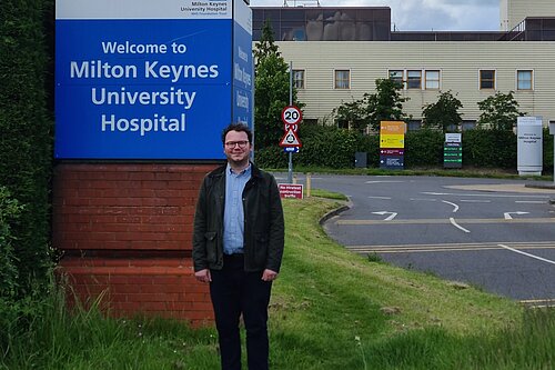 James Cox standing at the front of Milton Keynes Hospital